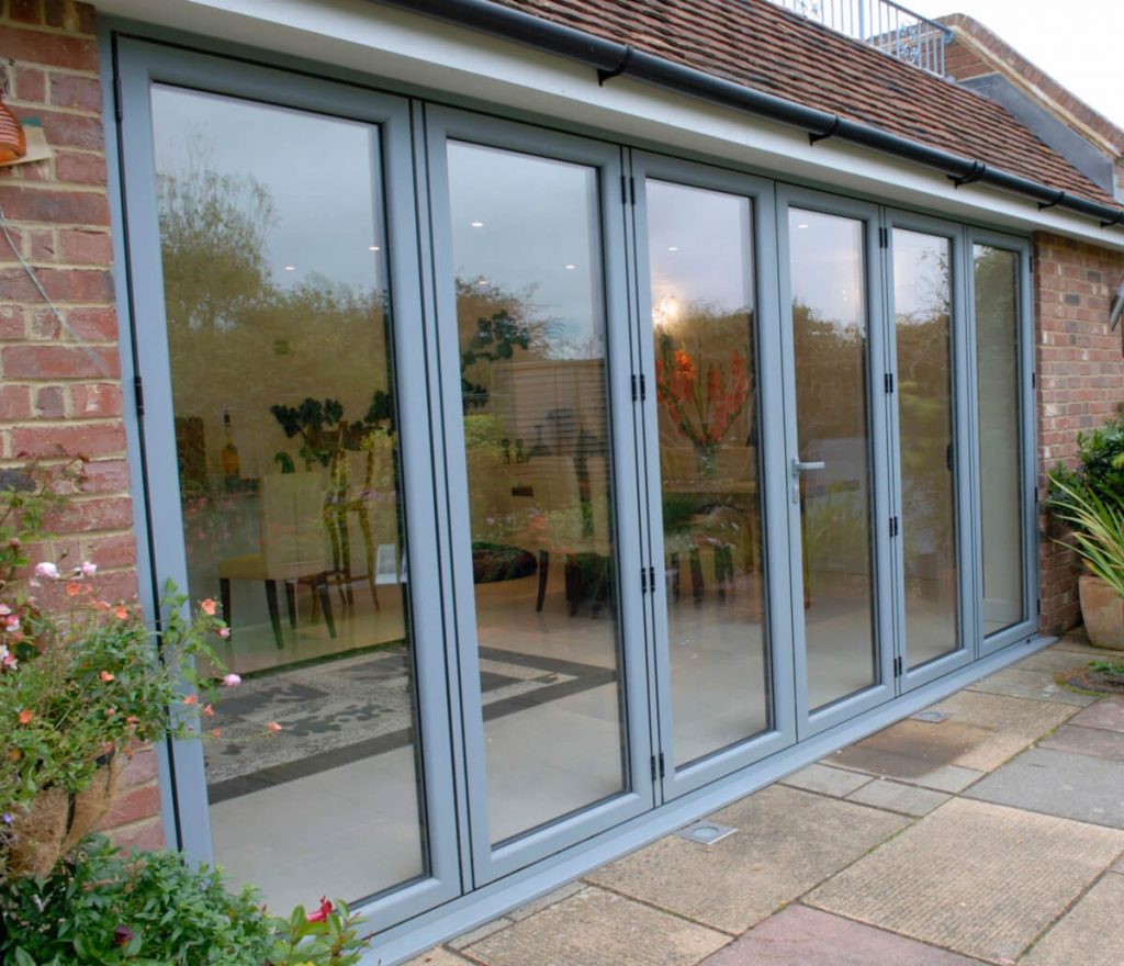 Aluminium bi-folding doors in Grey