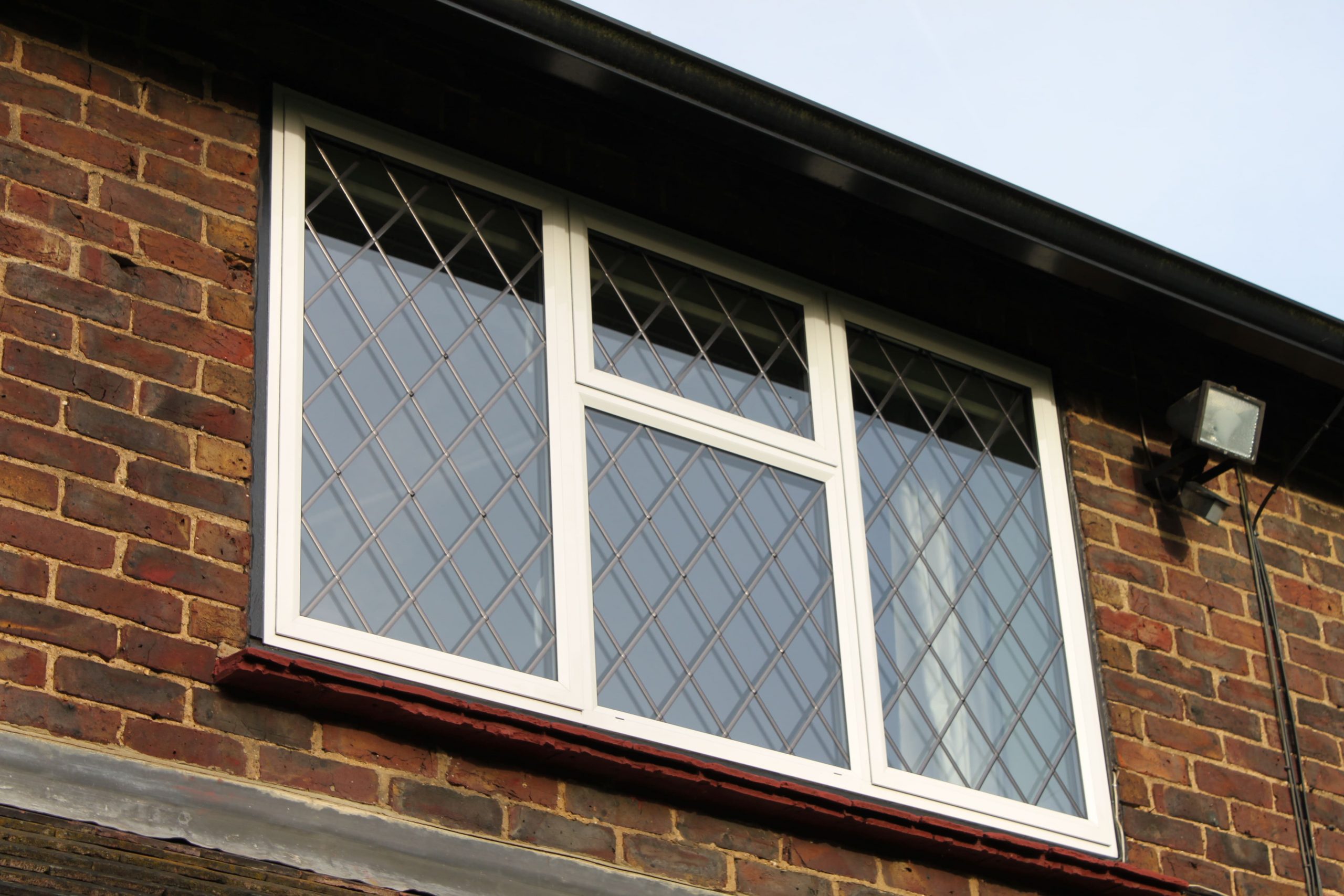 White aluminium secondary glazed window with leads