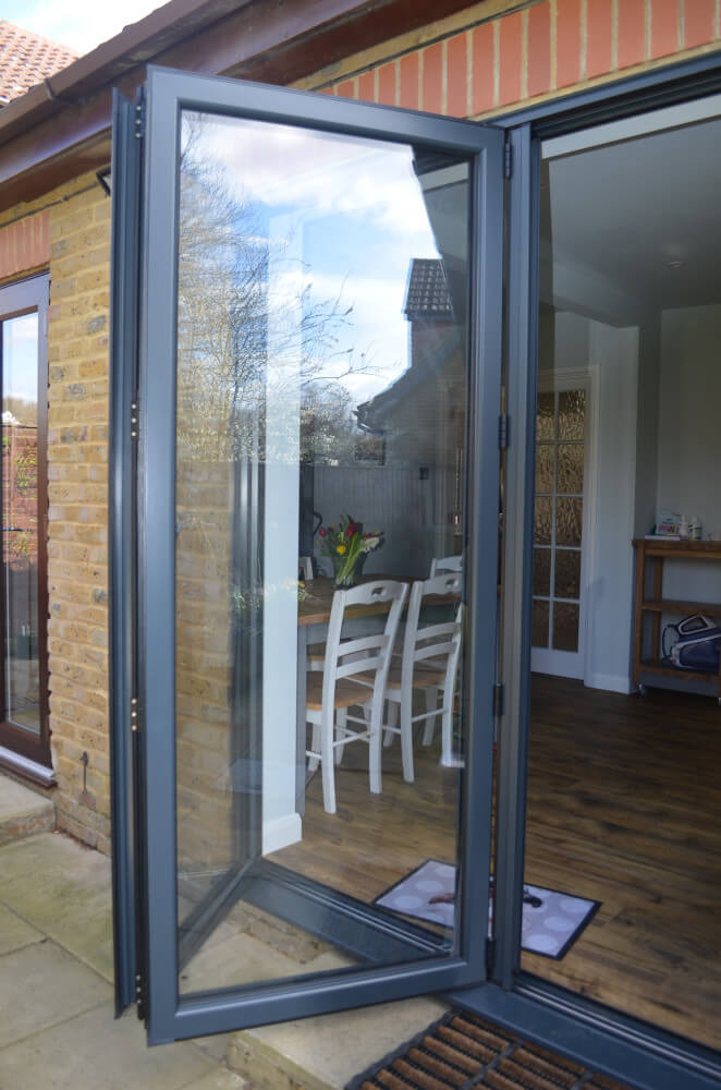 anthracite grey bifold doors opened