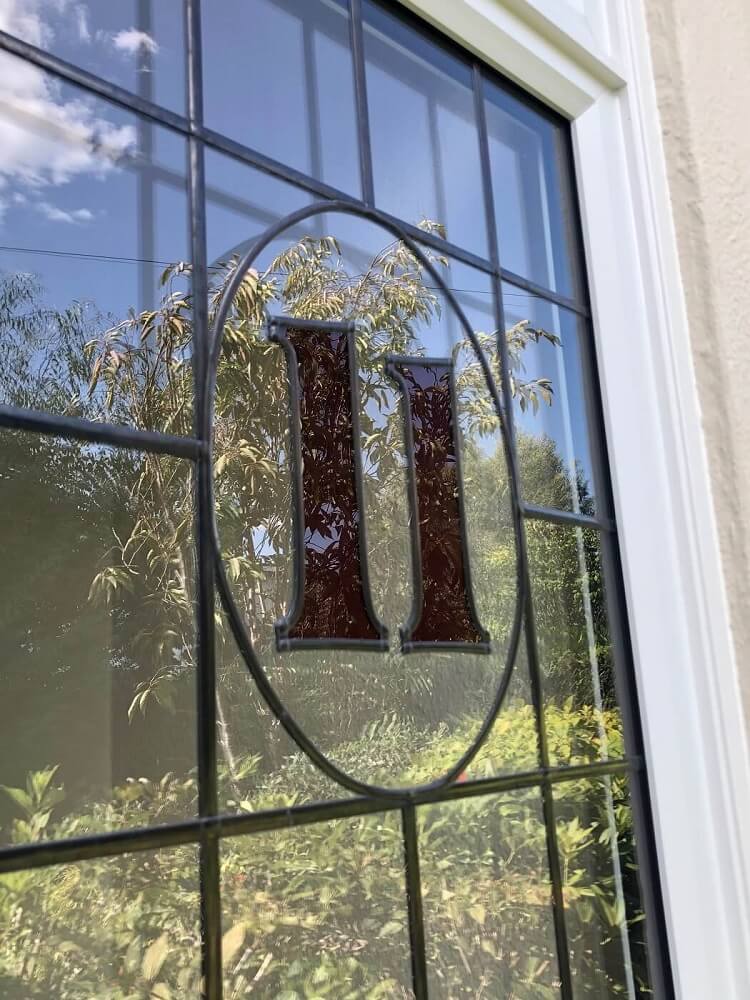 close up of glass window in porch with door number