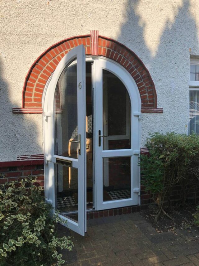 white upvc arched door open