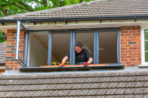close up of fitter installing window
