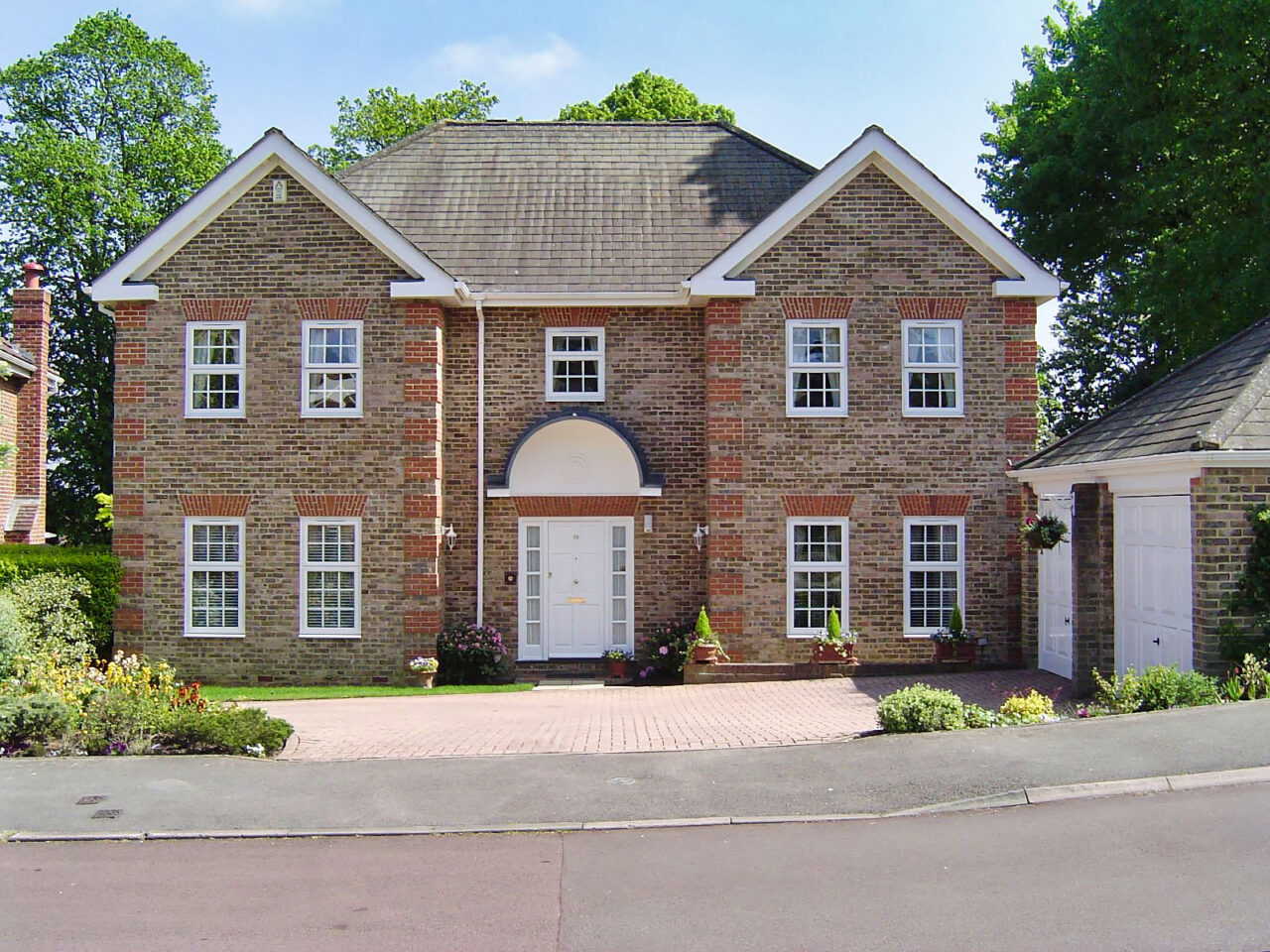 White uPVC sash windows fitted to a period house front in Surrey
