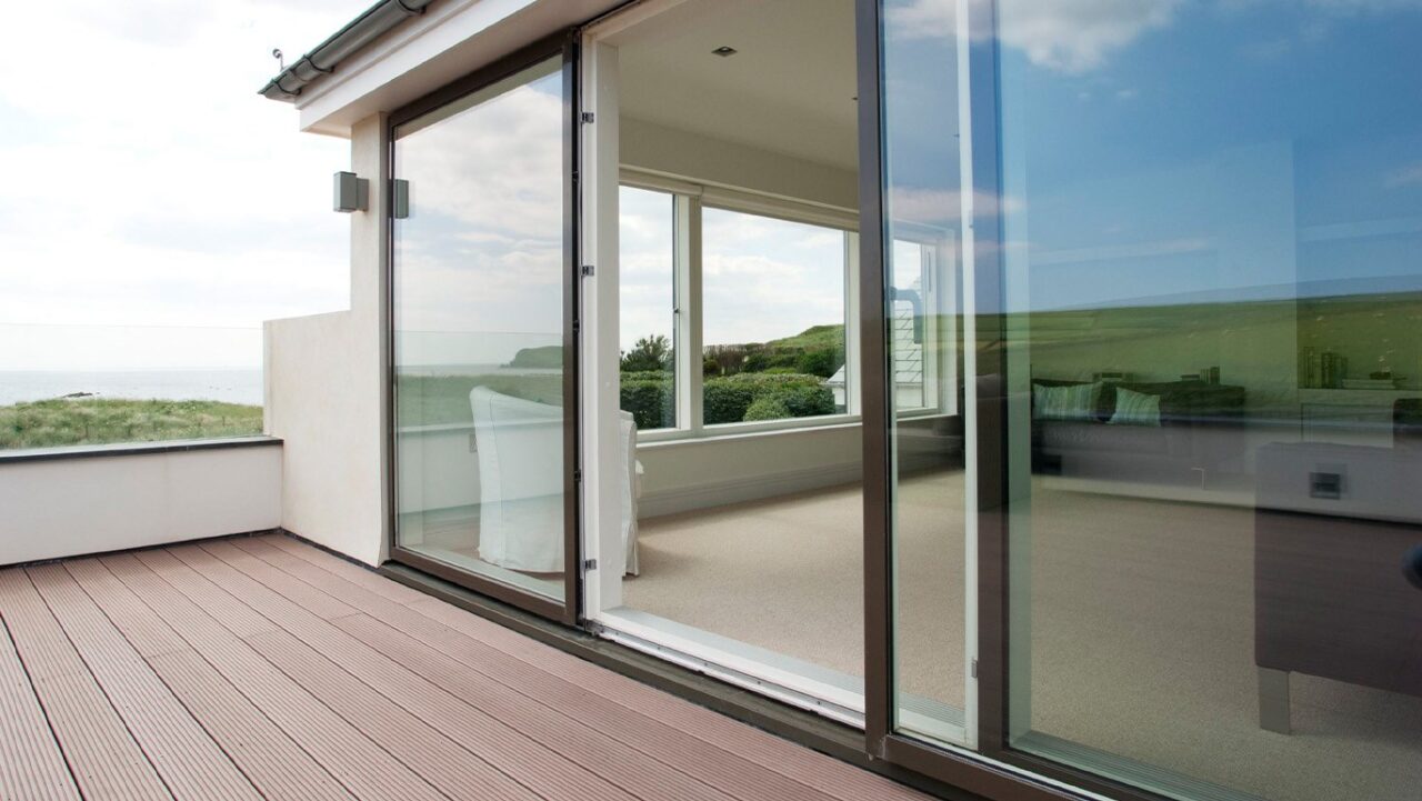 VEFLAC sliding door looking from balcony with a view both into the front room and also across the balcony to the view of the sea and countryside.